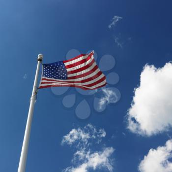 Royalty Free Photo of an American Flag Flying With Clouds in the Sky