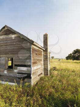 Royalty Free Photo of an Abandoned Rural Wooden House in a State of Disrepair