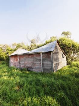Royalty Free Photo of an Abandoned Wooden Barn in a Field