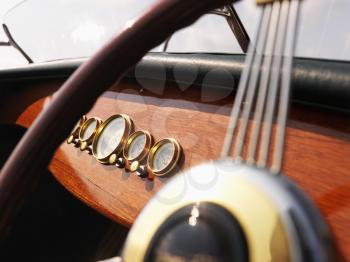 Royalty Free Photo of a Wooden Boat With Steering Wheel and Dashboard