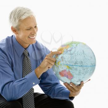 Royalty Free Photo of a Man Pointing on a Globe