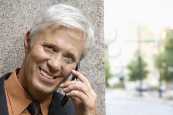 Royalty Free Photo of a Middle-aged Businessman Talking on a Mobile Phone