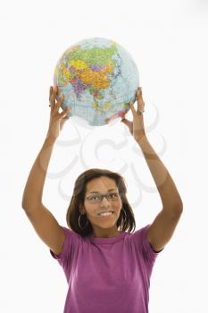 Royalty Free Photo of a Woman Holding a Globe Over Her Head and Smiling
