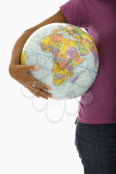 Royalty Free Photo of a Woman Holding a Globe on Her Hip