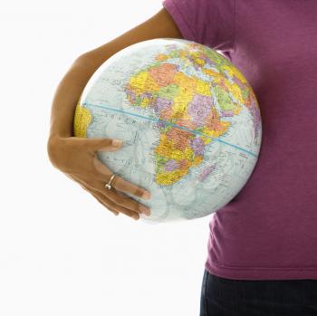 Royalty Free Photo of a Woman Holding a Globe on Her Hip