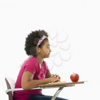 Royalty Free Photo of a Girl Sitting in a School Desk