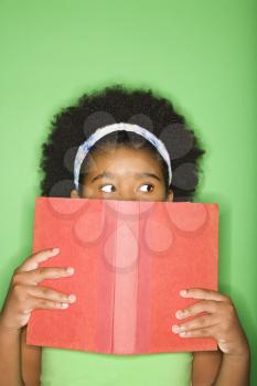 Royalty Free Photo of a Girl With a Book Held up to Her Face