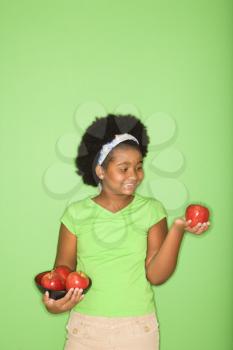 Royalty Free Photo of a Girl Holding Apples
