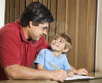 Royalty Free Photo of a Father Helping His Son With Homework