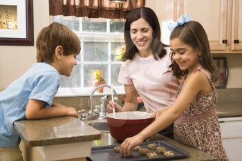 Royalty Free Photo of a Mother and Children Baking Cookies