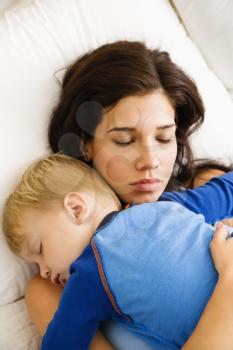 Royalty Free Photo of a Mother With Toddler Son Sleeping in Bed 