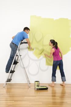 Royalty Free Photo of a Couple Painting a Wall