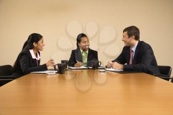 Royalty Free Photo of Businesspeople Sitting at a Conference Table Talking