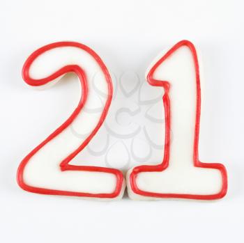 Royalty Free Photo of Sugar Cookies in the Shape of the Number Twenty One Outlined in Red Icing