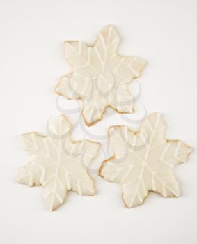 Royalty Free Photo of Three Snowflake Sugar Cookies With Decorative Icing