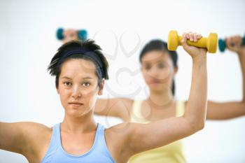 Royalty Free Photo of Women at the Gym Lifting Hand Weights