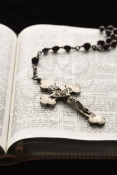 Royalty Free Photo of a Rosary With a Crucifix Lying on an Open Bible