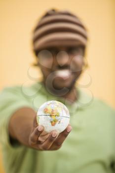 Royalty Free Photo of a Man Holding a Small Globe