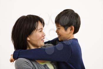Royalty Free Photo of an Asian mother and son hugging and smiling