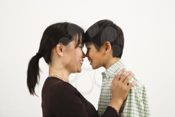 Royalty Free Photo of a Mother and Young Son Touching Noses and Smiling