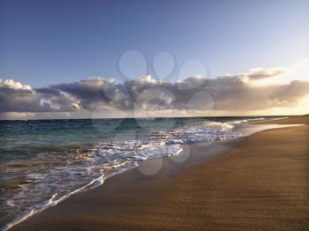 Royalty Free Photo of Waves Lapping on the Beach at Dusk in Maui, Hawaii
