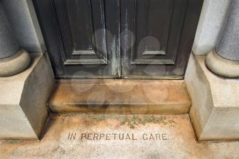 Royalty Free Photo of an Entrance to a Mausoleum in a Graveyard With Words, 'In Perpetual Care'