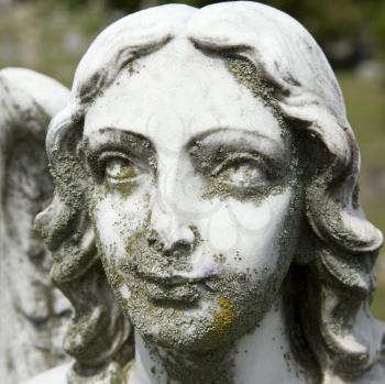 Royalty Free Photo of a Close-up of Guardian Angel Statue's Face in a Graveyard