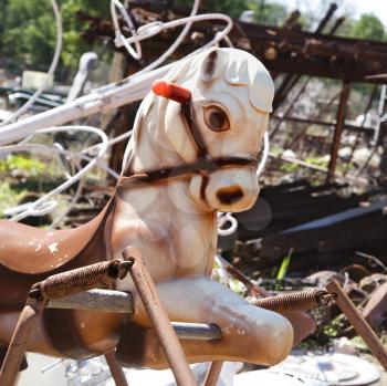Royalty Free Photo of an Old Abandoned Playground Toy Horse in a Junkyard