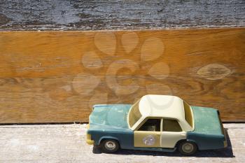 Royalty Free Photo of a Toy Police Car on a Wooden Shelf