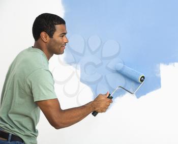 Royalty Free Photo of a Man Painting a Wall Blue