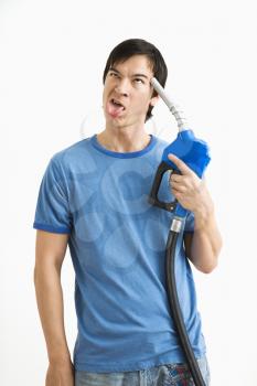 Royalty Free Photo of a Man Aiming Gasoline Pump Nozzle to His Head