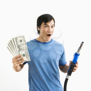 Royalty Free Photo of a Man Holding Money and a Gas Pump Nozzle