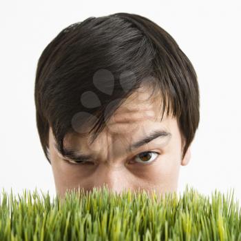 Royalty Free Photo of a Man Looking Over Grass