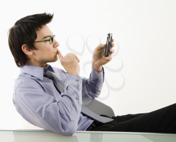 Royalty Free Photo of a Businessman Using His PDA Cellphone