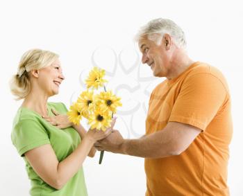 Royalty Free Photo of a Man Giving a Woman a Bouquet of Yellow Flowers
