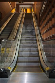 Low angle view of escalators in an office building. Vertical shot.