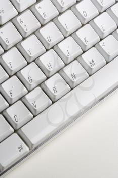 Close up of a white computer keyboard. Vertical shot.