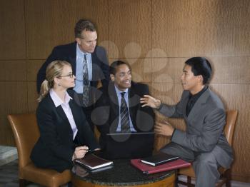 Ethnically diverse group of businessmen and a businesswoman having an enjoyable meeting together. Horizontal shot.