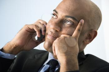African American businessman holding cellphone to ear.