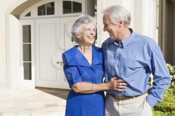 Royalty Free Photo of a Senior Couple Outside Their Home