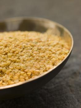 Royalty Free Photo of a Dish of Split Yellow Mustard Seeds