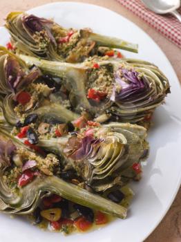 Royalty Free Photo of Roasted Globe Artichokes With Aubergine Peppers and Olives