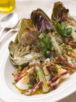 Royalty Free Photo of Roasted Globe Artichokes With Pancetta Egg and Garlic Breadcrumbs