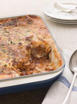 Royalty Free Photo of a Pan of Lasagna With a Serving Gone