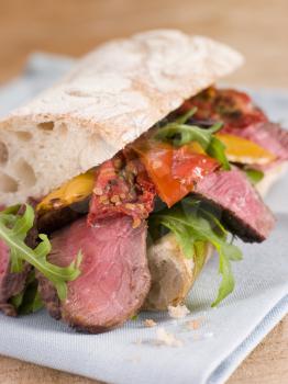 Royalty Free Photo of a Sirloin Steak and Roasted Pepper Ciabatta Sandwich