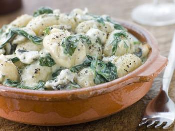 Royalty Free Photo of a Dish of Gnocchi and Spinach With a Gorgonzola Cream Sauce