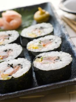 Royalty Free Photo of Large Spiral Rolled Sushi With Sushi Ginger Wasabi and Soy Sauce