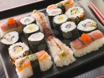 Royalty Free Photo of a Selection of Seafood and Vegetable Sushi on a Tray With Chopsticks