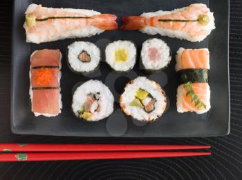 Royalty Free Photo of a Selection of Seafood And Vegetable Sushi With Chopsticks From Overhead