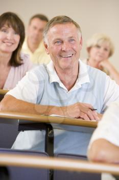 Royalty Free Photo of a Smiling Man in a Classroom